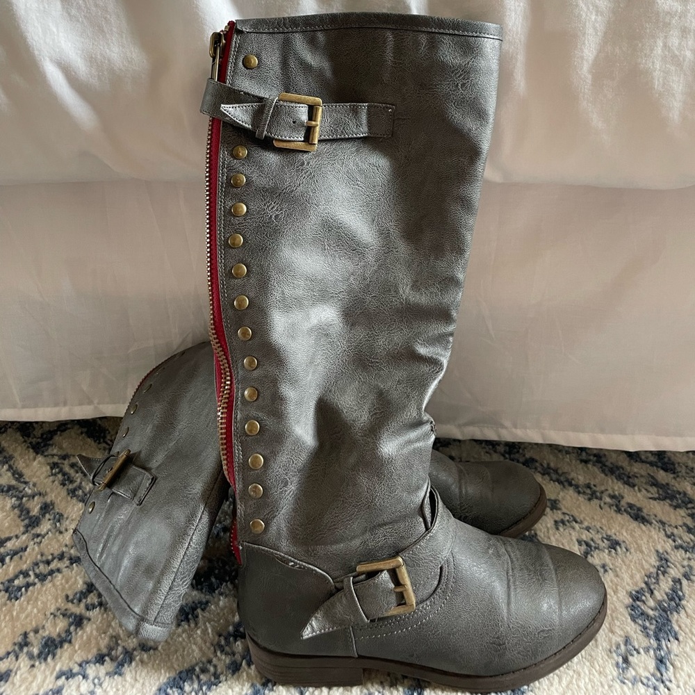Grey riding boots with studs and red stitch details